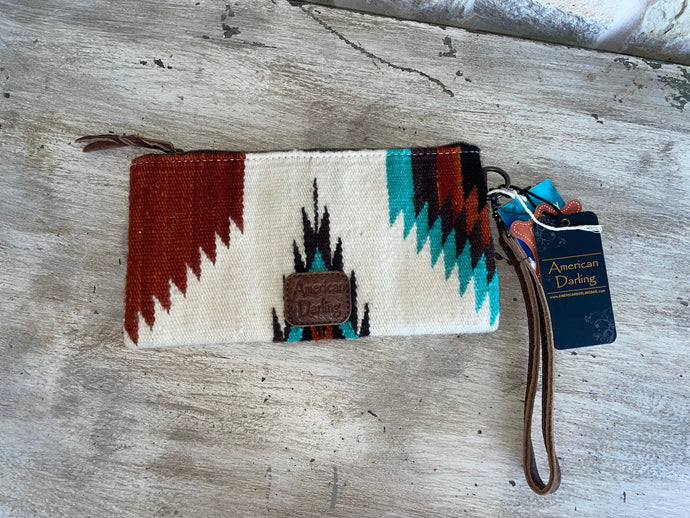 Cream, turquoise, and rust colored American Darling wristlet/clutch