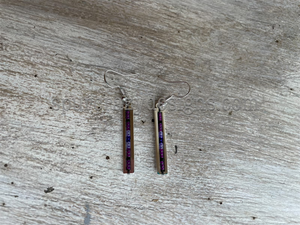 purple bar earrings on table