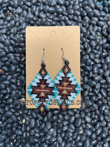 Rhombus shaped beaded earrings made with turquoise, brown, black, white, and gold colored glass beads, has wire hooks, made by Spur Crazy Designs.