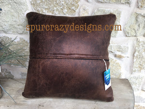 Brown micro suede back on brown trimmed pillows.
